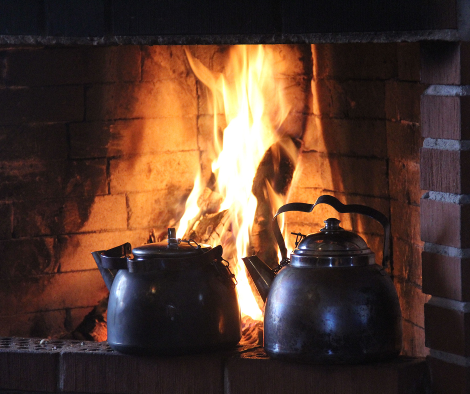A warm fire in a hearth, symbolizing a space for quiet and guided silence